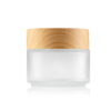 frosted glass skincare jar with wooden lid